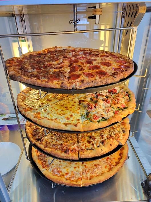 Pizzas stacked on the rack